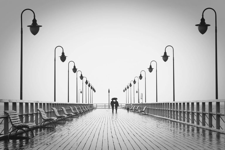 two people walking on pier