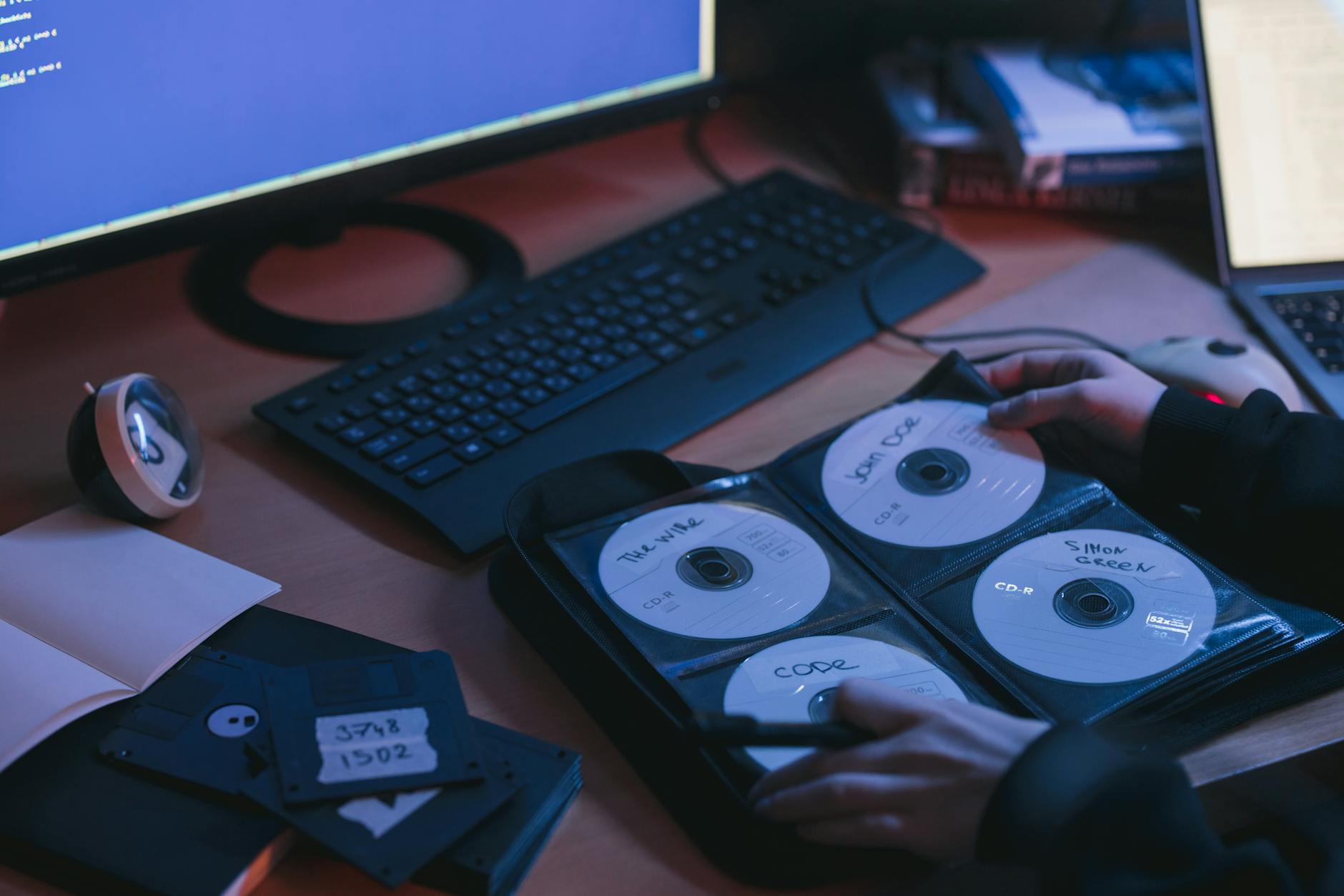 person holding cds